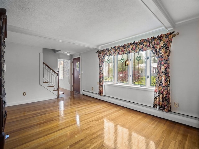 47 Skelton Rd, Burlington, MA 01803 - unfurnished living room featuring a baseboard radiator, a textured ceiling, wood finished floors, stairway, and ornamental molding