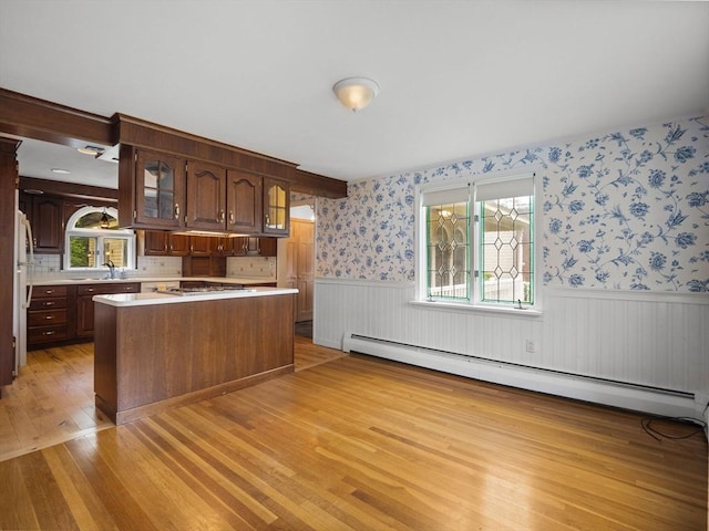 47 Skelton Rd, Burlington, MA 01803 - kitchen with baseboard heating, light wood-style floors, wainscoting, light countertops, and a kitchen island