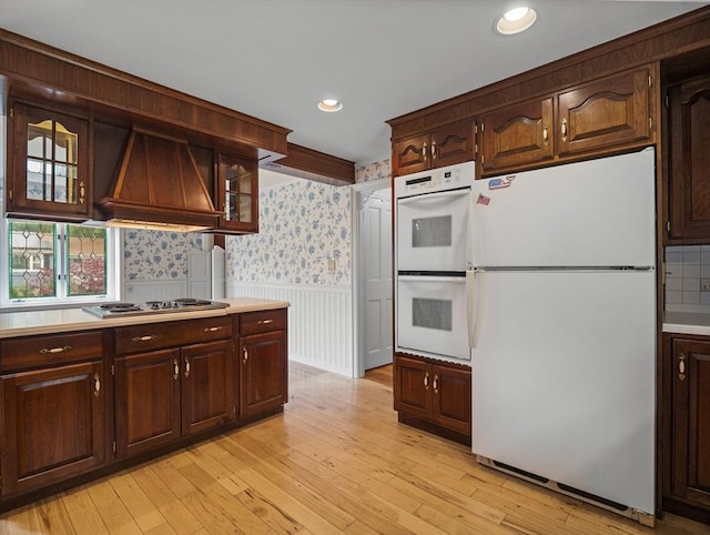 47 Skelton Rd, Burlington, MA 01803 - kitchen with white appliances, custom exhaust hood, a wainscoted wall, glass insert cabinets, and light countertops