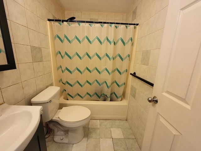 full bathroom with tile walls, shower / tub combo, vanity, and toilet