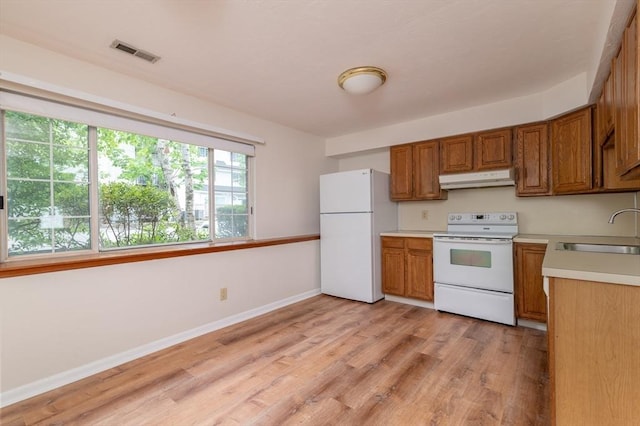 118 Tall Oaks Dr Unit D, Weymouth, MA 02190 - kitchen with white appliances, a sink, under cabinet range hood, and brown cabinets