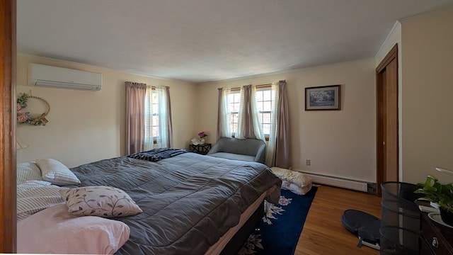 bedroom with wood-type flooring, baseboard heating, and a wall mounted AC