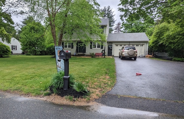 view of front facade with a front yard and a garage