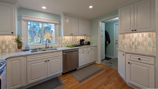 kitchen featuring white cabinets, decorative backsplash, sink, and appliances with stainless steel finishes