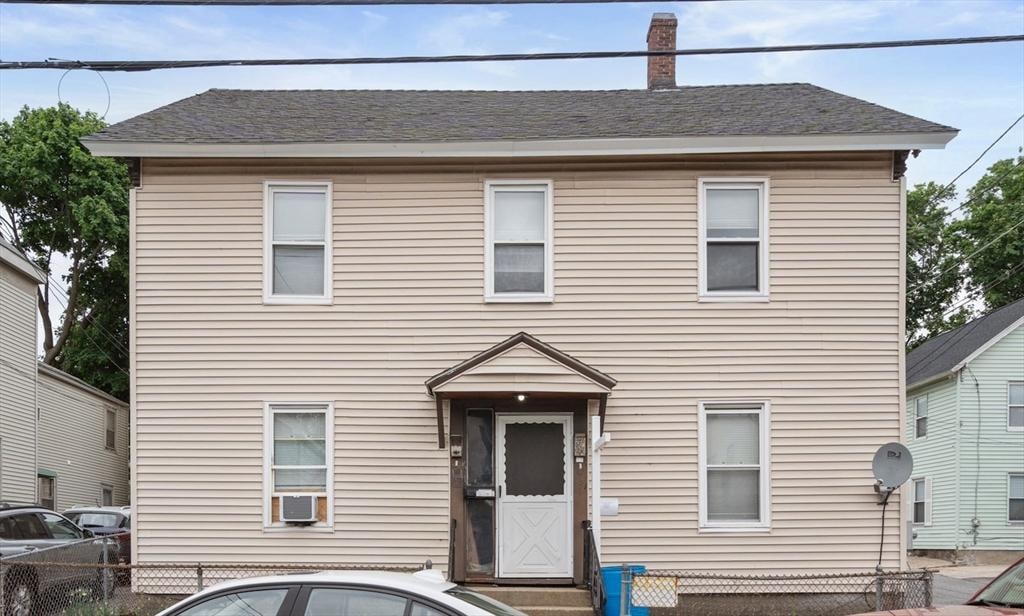 153 Cross St, Lowell, MA 01854 - view of front of home featuring a chimney