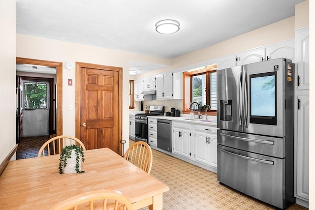 14 Giles Ave, Beverly, MA 01915 - kitchen with stainless steel appliances, white cabinetry, light countertops, and under cabinet range hood