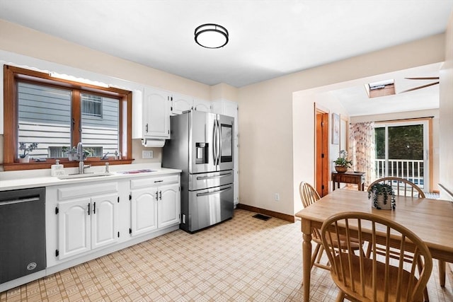 14 Giles Ave, Beverly, MA 01915 - kitchen with appliances with stainless steel finishes, white cabinetry, light countertops, and light floors
