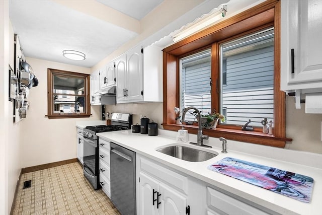 14 Giles Ave, Beverly, MA 01915 - kitchen featuring appliances with stainless steel finishes, white cabinets, light countertops, under cabinet range hood, and light floors