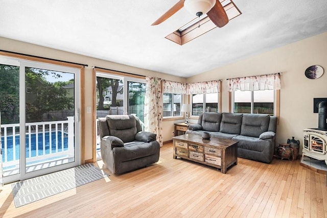 14 Giles Ave, Beverly, MA 01915 - living room with a wood stove, ceiling fan, light wood-style flooring, a skylight, and lofted ceiling