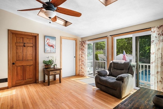 14 Giles Ave, Beverly, MA 01915 - living area featuring lofted ceiling, light wood finished floors, ceiling fan, and a skylight
