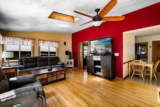 14 Giles Ave, Beverly, MA 01915 - living area with a wood stove, a ceiling fan, light wood-style floors, and a skylight