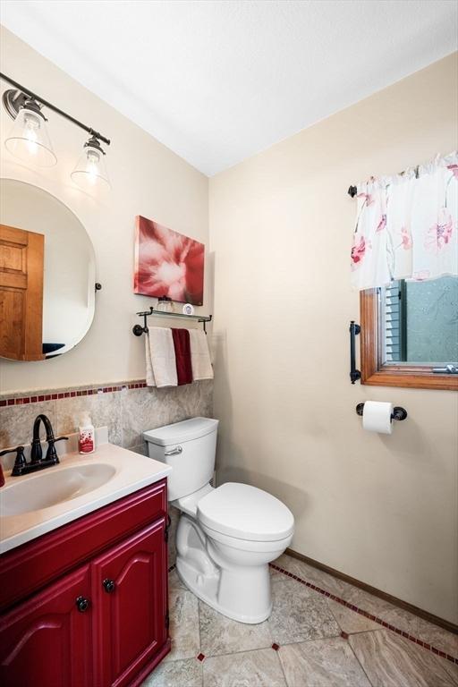14 Giles Ave, Beverly, MA 01915 - bathroom with vanity, tile patterned flooring, and tile walls