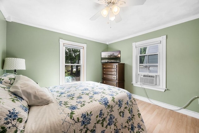 14 Giles Ave, Beverly, MA 01915 - bedroom with multiple windows, wood finished floors, ornamental molding, cooling unit, and ceiling fan