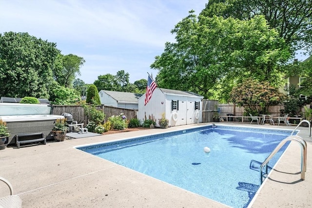 14 Giles Ave, Beverly, MA 01915 - view of swimming pool with a hot tub, a fenced backyard, a patio, and a storage unit