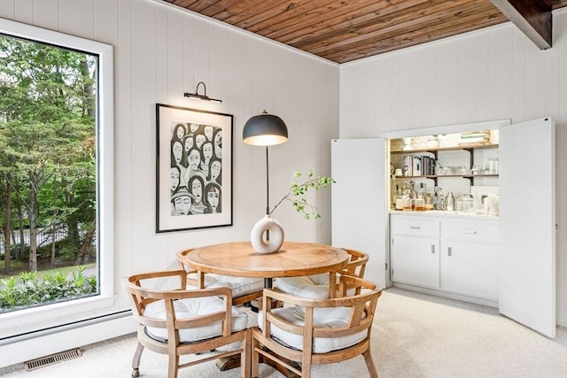 228 Atlantic Ave, Swampscott, MA 01907 - dining space featuring wooden ceiling, wood walls, and light colored carpet