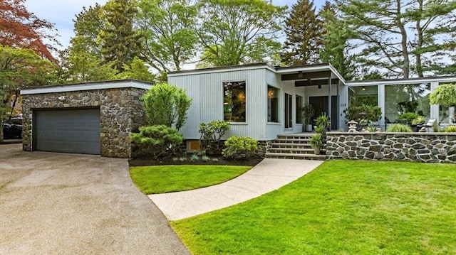 228 Atlantic Ave, Swampscott, MA 01907 - mid-century home with driveway, a front lawn, and a garage