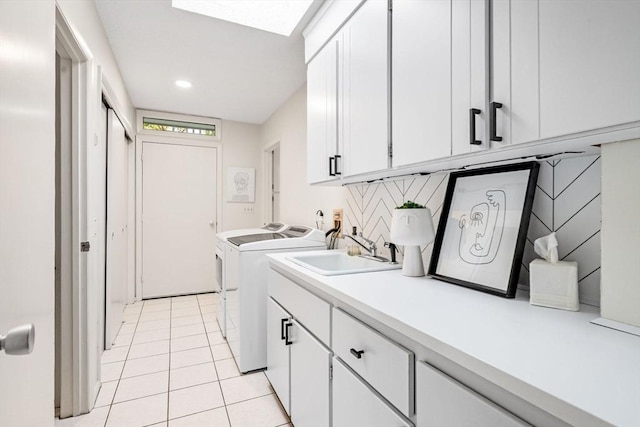 228 Atlantic Ave, Swampscott, MA 01907 - washroom with separate washer and dryer, cabinet space, and light tile patterned flooring