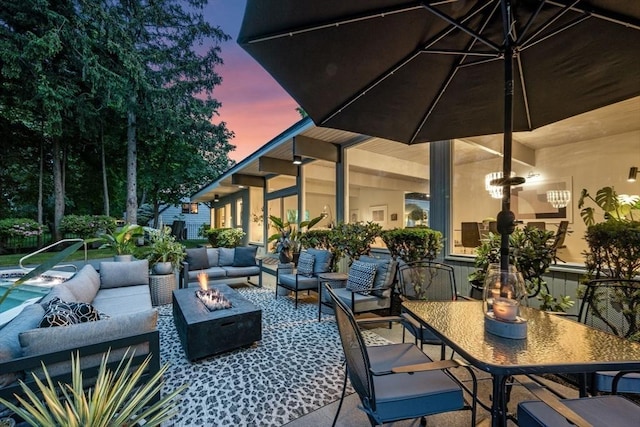 228 Atlantic Ave, Swampscott, MA 01907 - patio terrace at dusk with an outdoor living space with a fire pit, a patio area, and outdoor dining space