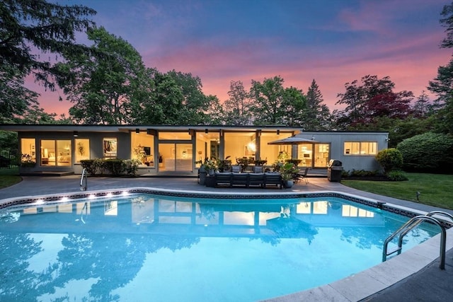 228 Atlantic Ave, Swampscott, MA 01907 - pool at dusk featuring an outdoor pool, an outdoor hangout area, a patio area, and a lawn