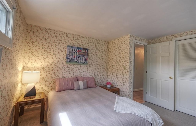 carpeted bedroom featuring wallpapered walls