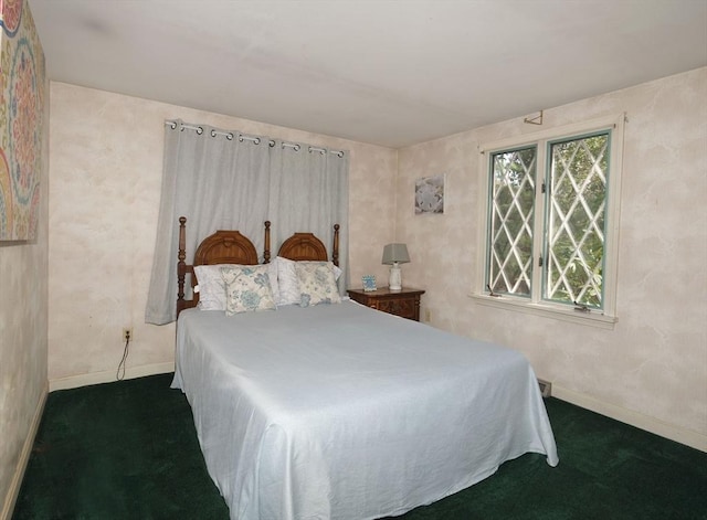 bedroom featuring dark colored carpet and baseboards