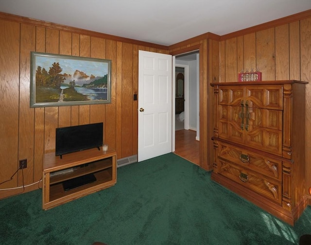 living area with carpet and wood walls
