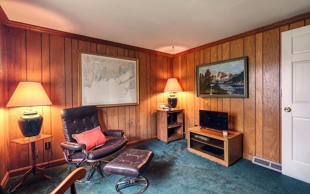 living area featuring carpet flooring, wood walls, and baseboards
