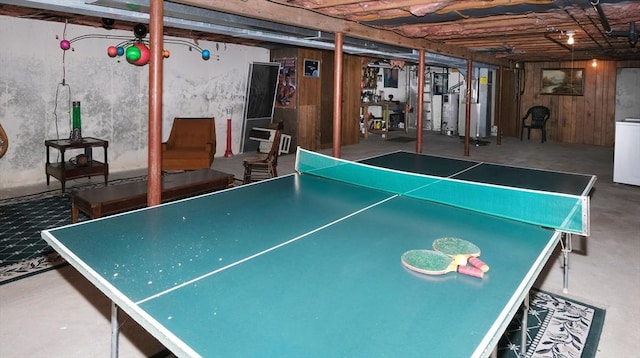 game room with concrete flooring, washer / dryer, and gas water heater