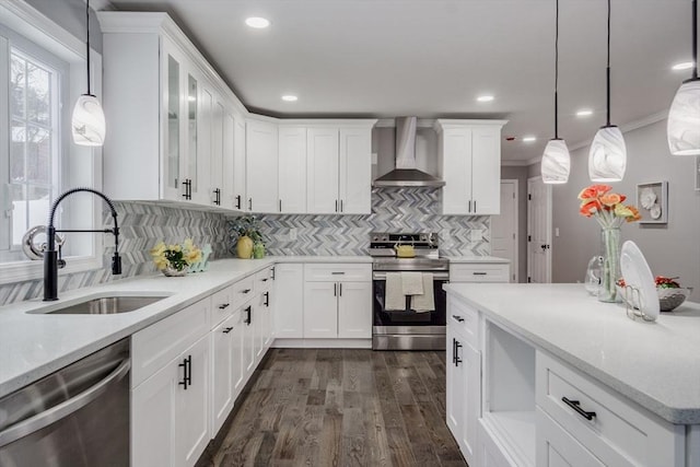 kitchen featuring stainless steel appliances, white cabinets, a sink, and wall chimney exhaust hood