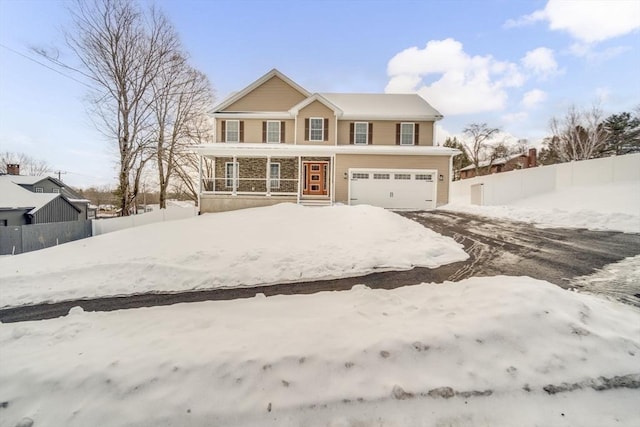 traditional home with an attached garage and fence