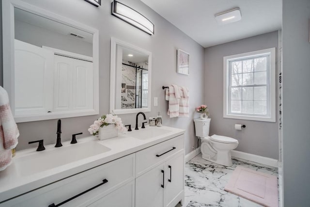 bathroom featuring double vanity, marble finish floor, visible vents, and a sink