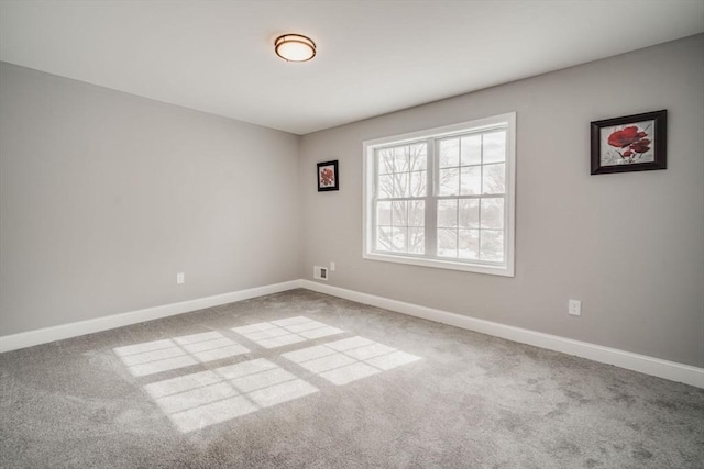 empty room with carpet floors and baseboards