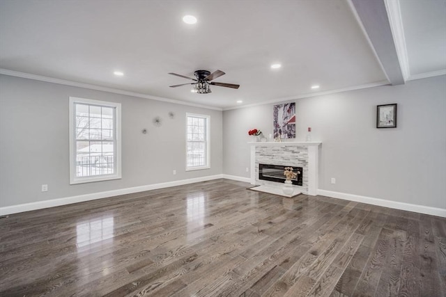 unfurnished living room with dark wood-style floors, crown molding, and a fireplace