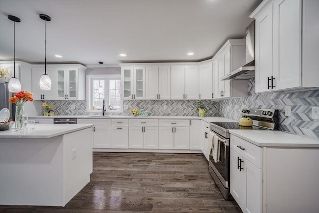 kitchen featuring white cabinets, light countertops, stainless steel electric range oven, glass insert cabinets, and pendant lighting