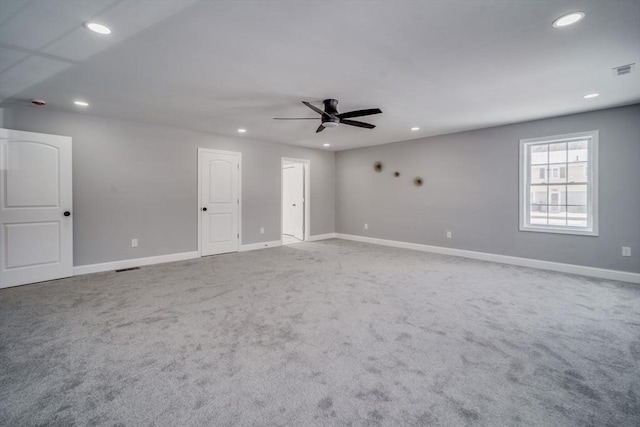 carpeted spare room featuring visible vents, baseboards, a ceiling fan, and recessed lighting