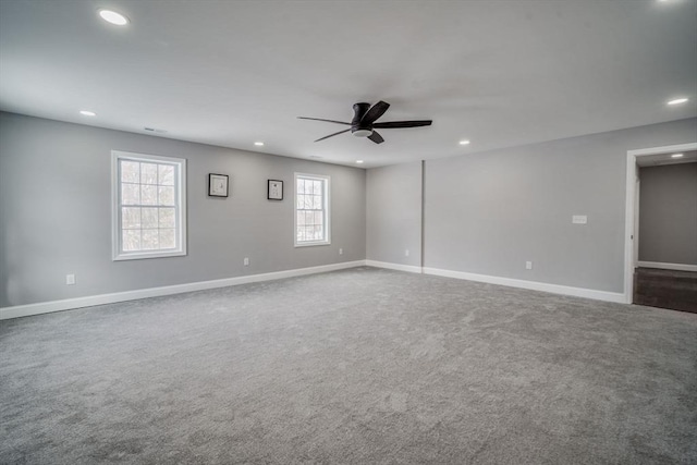 carpeted empty room with a ceiling fan, recessed lighting, visible vents, and baseboards