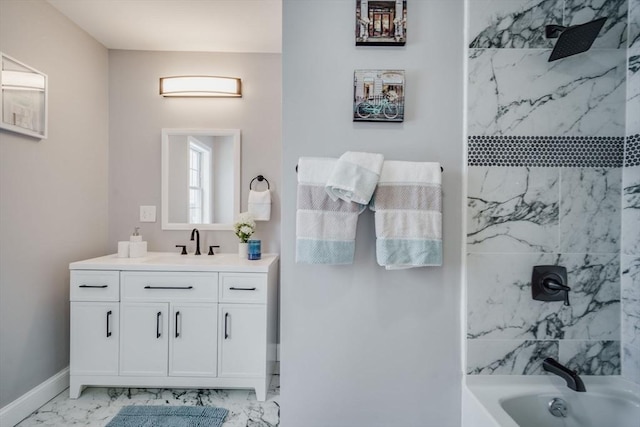 full bath featuring marble finish floor, bathtub / shower combination, vanity, and baseboards