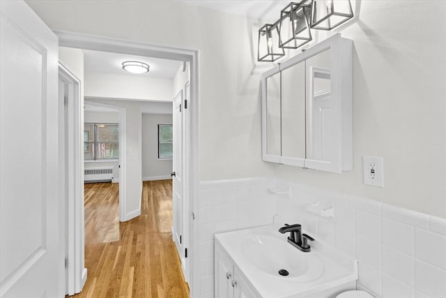 bathroom featuring radiator, vanity, and hardwood / wood-style flooring