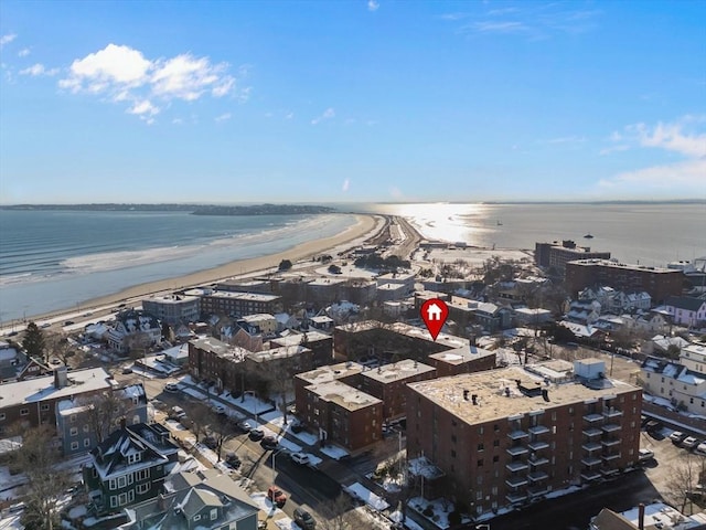 bird's eye view with a water view and a beach view