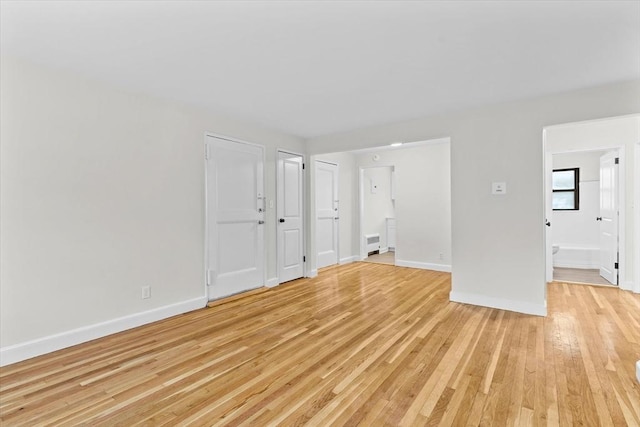 unfurnished room with light hardwood / wood-style floors