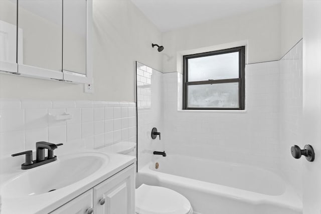 full bathroom featuring vanity, tiled shower / bath combo, toilet, tile walls, and tasteful backsplash