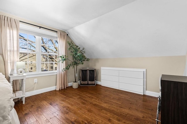 bonus room featuring dark hardwood / wood-style flooring and vaulted ceiling