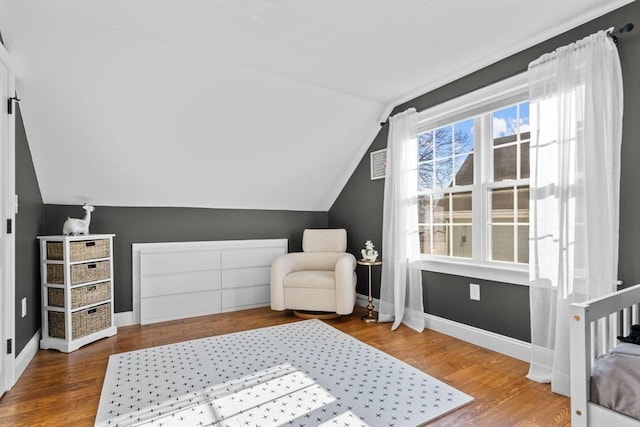 living area featuring lofted ceiling and hardwood / wood-style flooring