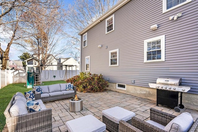 view of patio / terrace with an outdoor living space with a fire pit, grilling area, and a playground