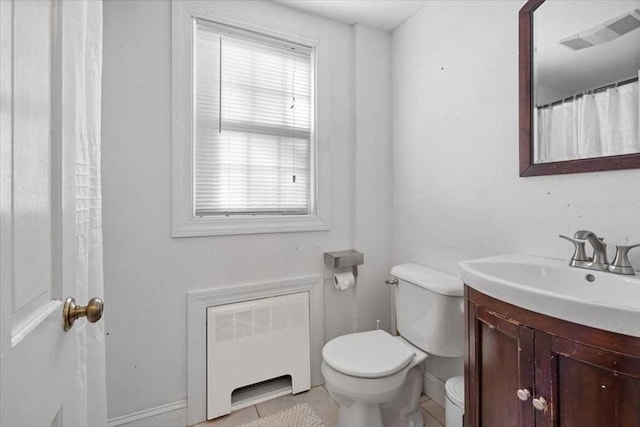 bathroom featuring toilet, radiator heating unit, vanity, and tile patterned flooring