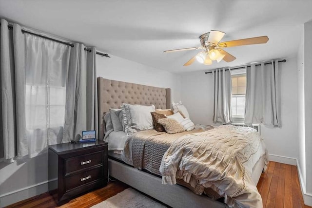 bedroom with ceiling fan and dark hardwood / wood-style floors