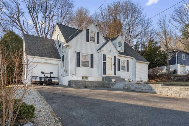 cape cod-style house with a garage