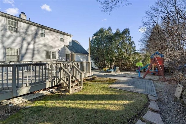 view of yard featuring a playground and a wooden deck