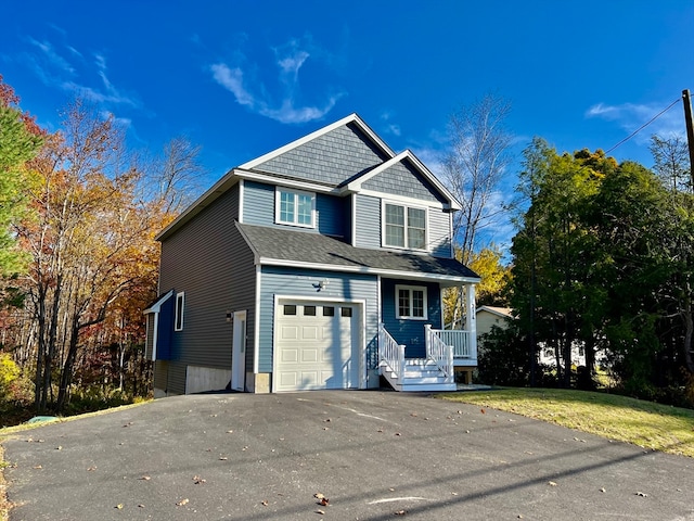 view of front of property with a front yard and a garage