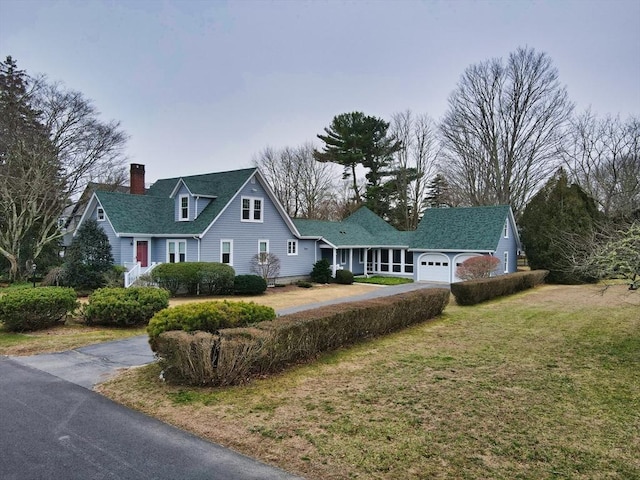 view of front of home featuring a garage and a front lawn